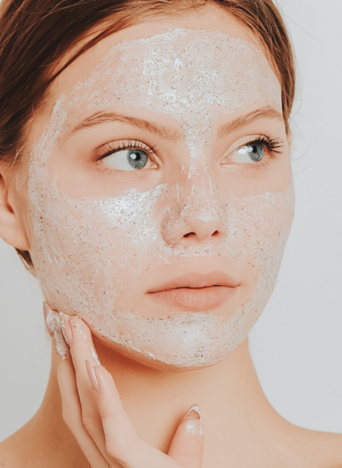 a women having cream facial on her face